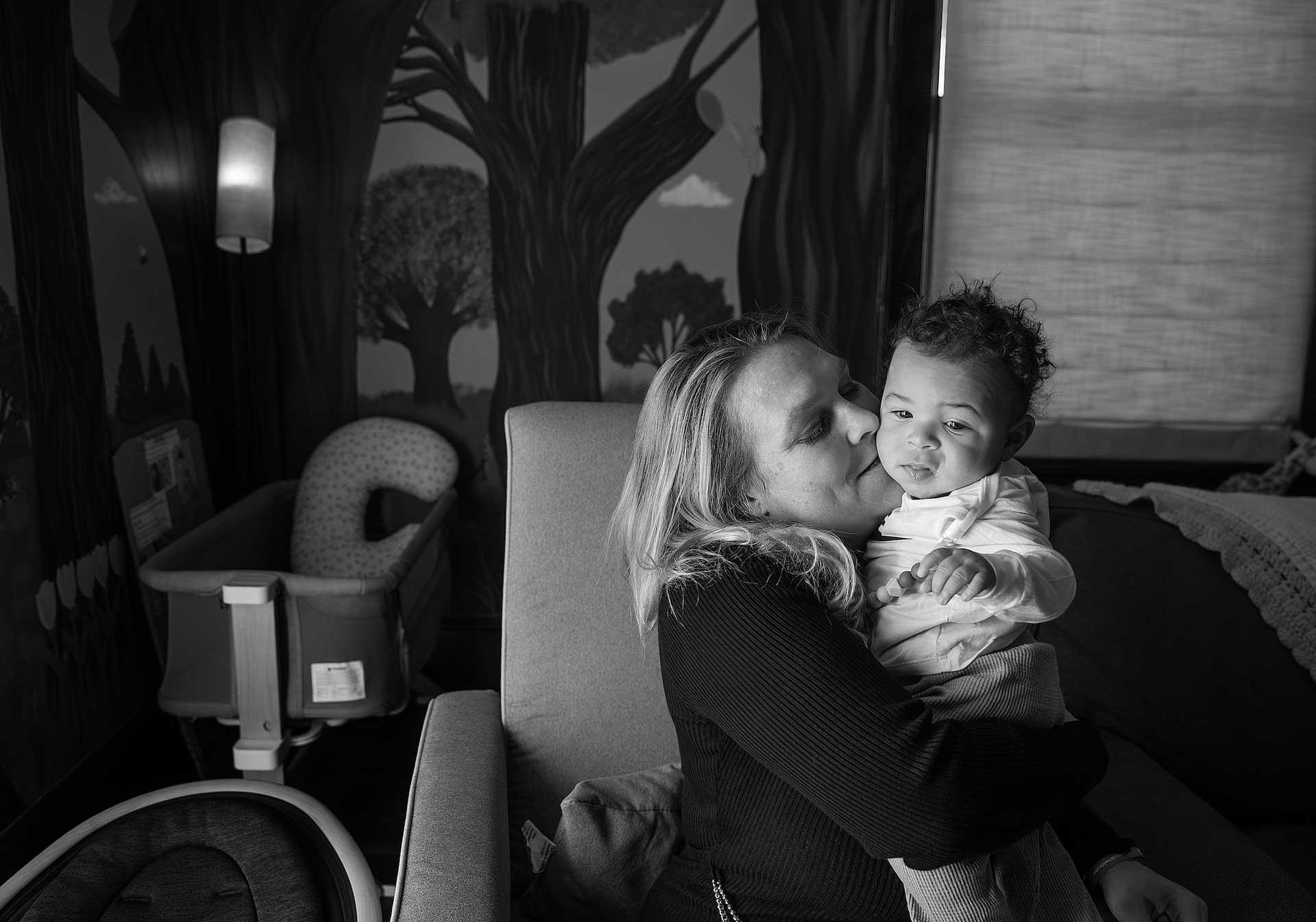 Mother smiling with her young baby at the Grove on Patterson addiction treatment house in Roanoke, Virginia